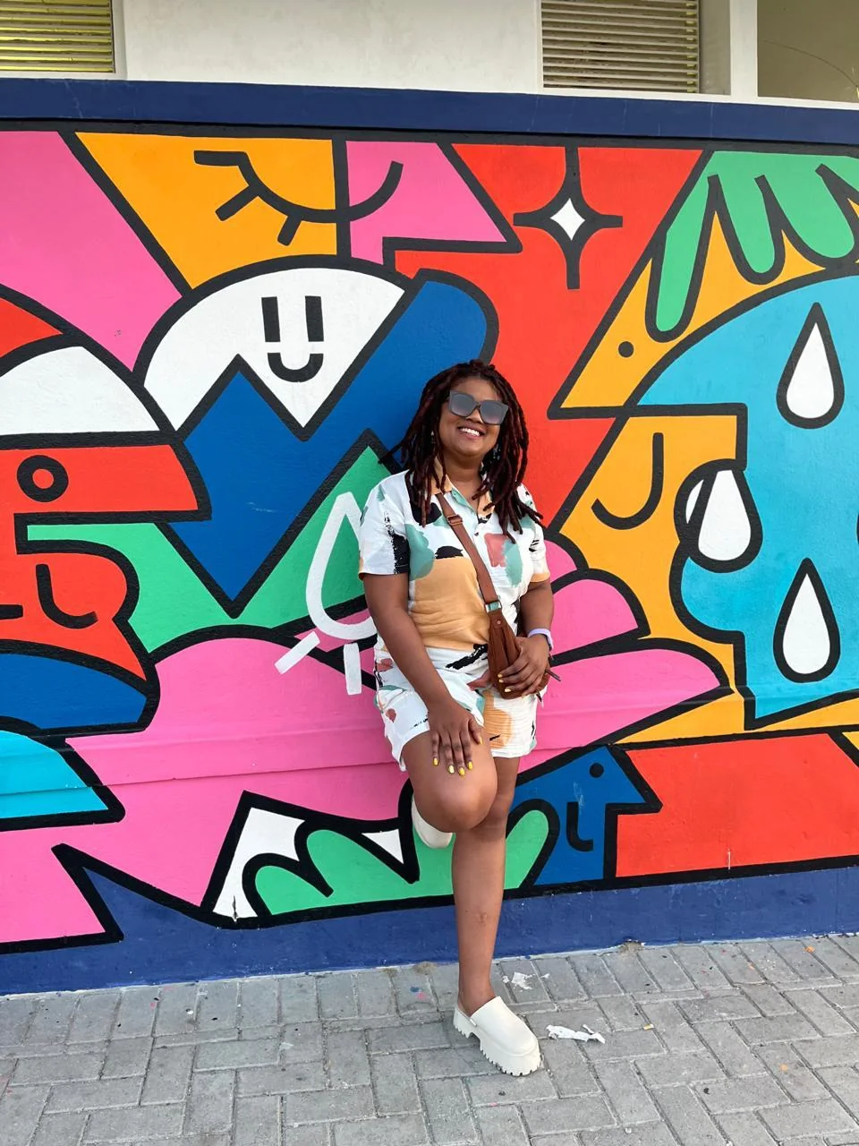 Janine Fortuin standing in front of a colourful Cape Town mural
